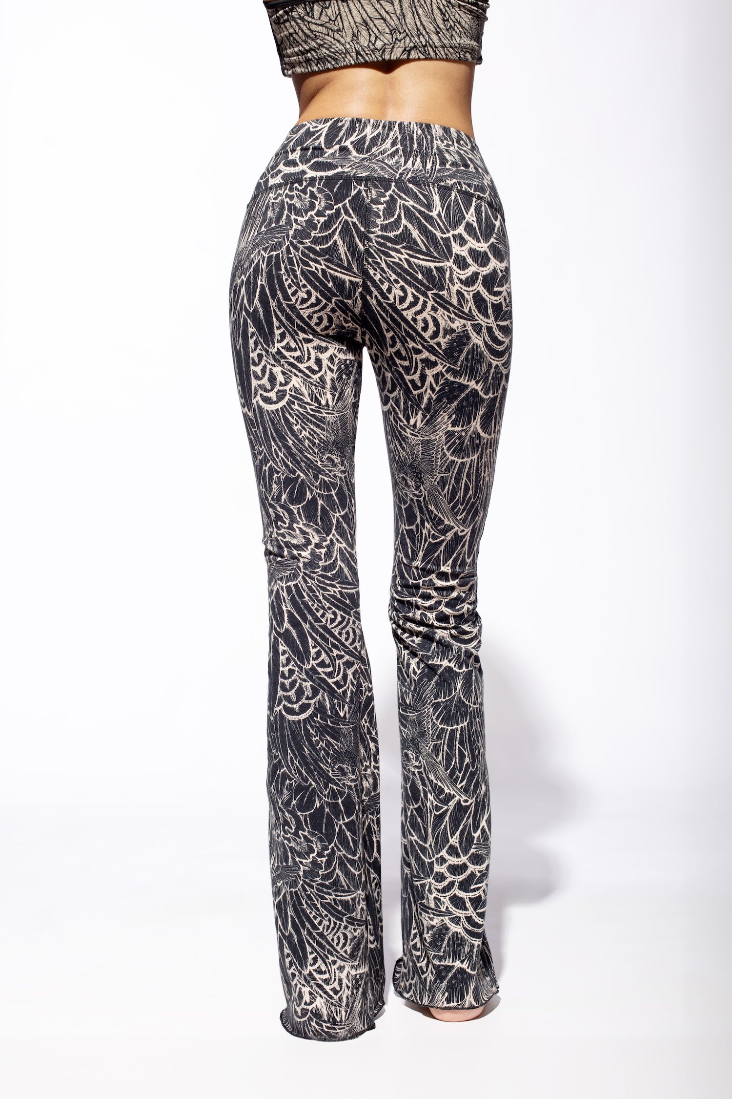 Woman wearing Feather Cream Black Flares seen from the back.