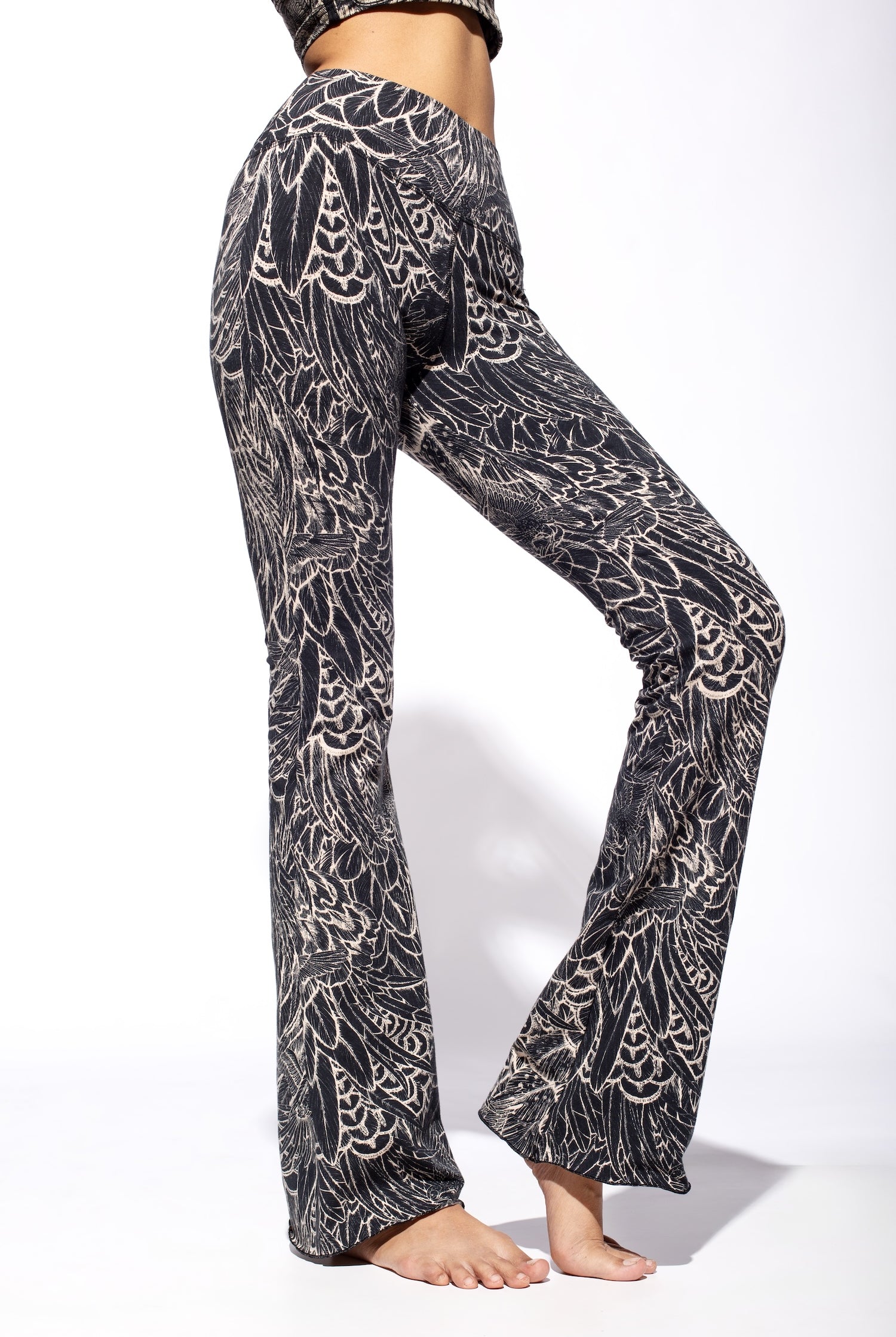 Woman wearing Feather Cream Black Flares seen from the side close up.