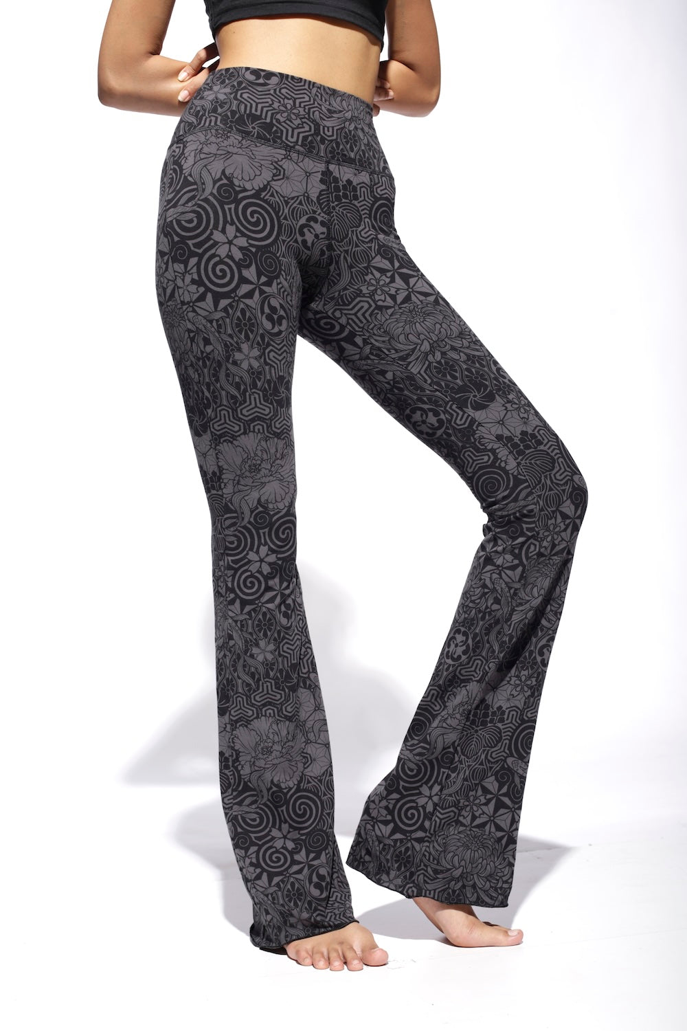 A pair of grey flared leggings with a high waist and bootcut design, featuring a geometric Nagomi print.