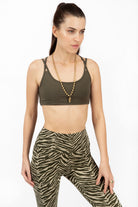 Woman wearing cream and olive zebra print high-waist leggings with a cross-back sport bra in comfortable cotton elastaan fabric from Funky Simplicity - perfect for yoga, fitness, and loungewear. Close-up front