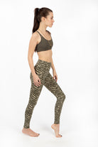Woman wearing cream and olive zebra print high-waist leggings in comfortable cotton elastaan fabric from Funky Simplicity - perfect for yoga, fitness, and loungewear. Sideways